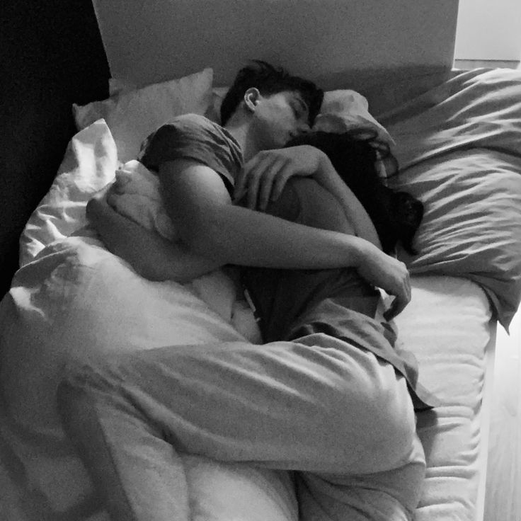 black and white photograph of a woman sleeping on a bed with her head in the pillow