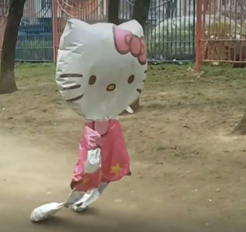 the hello kitty mascot is running in the park