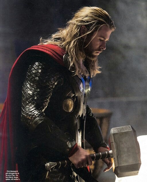 the man is dressed up as thor with an ax