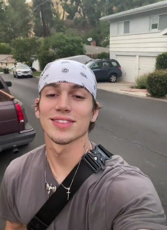 a young man is taking a selfie in the street