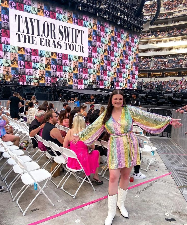 a woman standing in front of a crowd at a concert