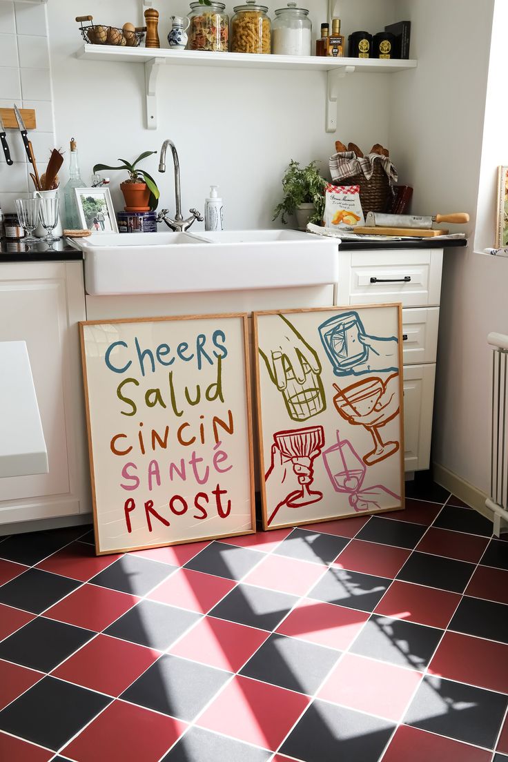 a kitchen with red and black tile flooring