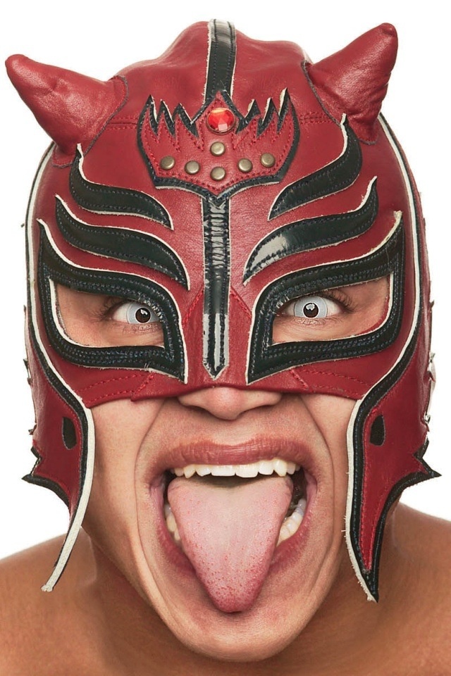 a man with his tongue out wearing a wrestling mask