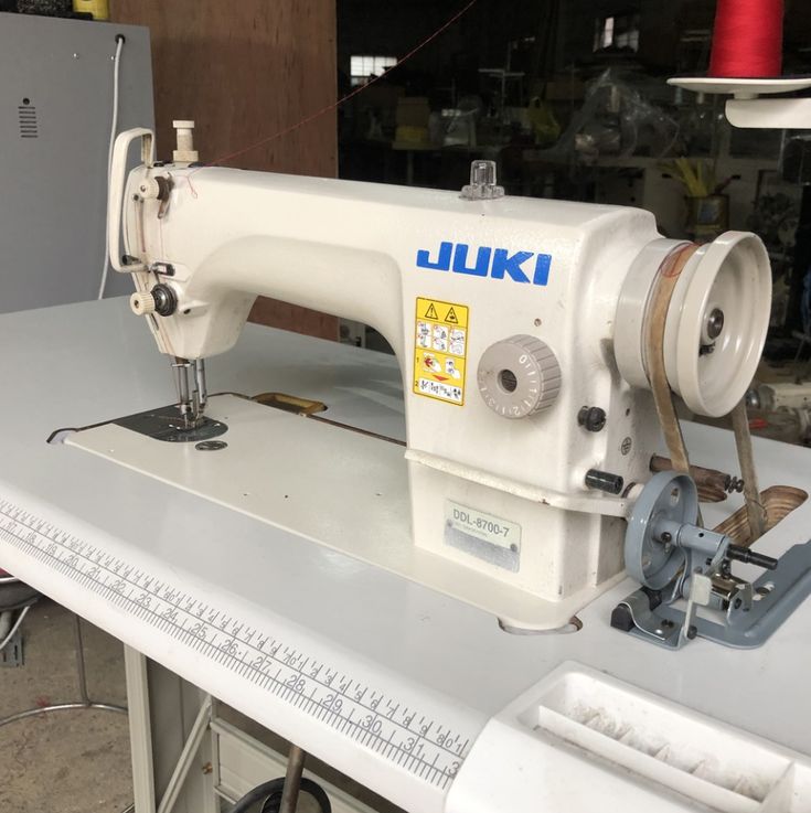 a white sewing machine sitting on top of a table