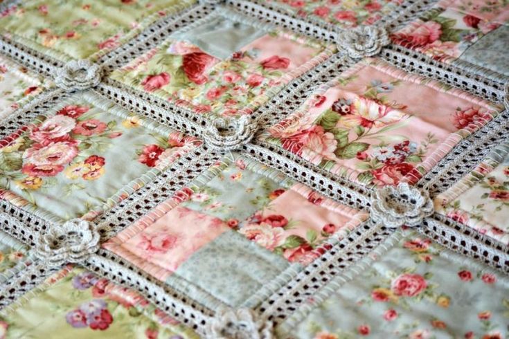 an old quilt with roses on it is shown in this close up photo, and the fabric has been stitched together