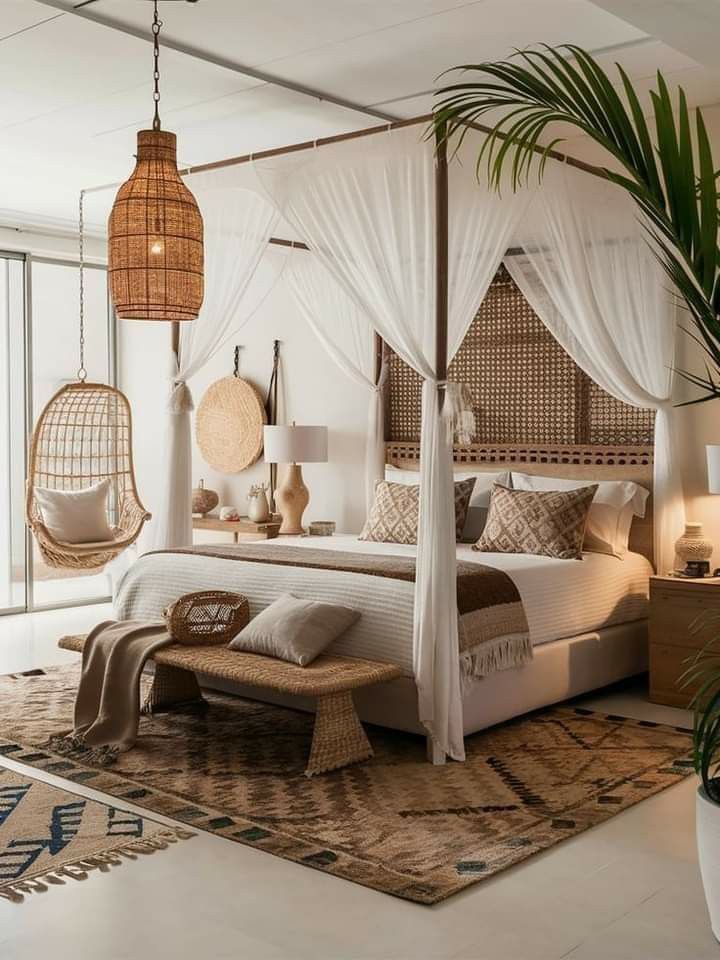 a bedroom with white bedding and hanging rattans on the ceiling, along with wicker furniture