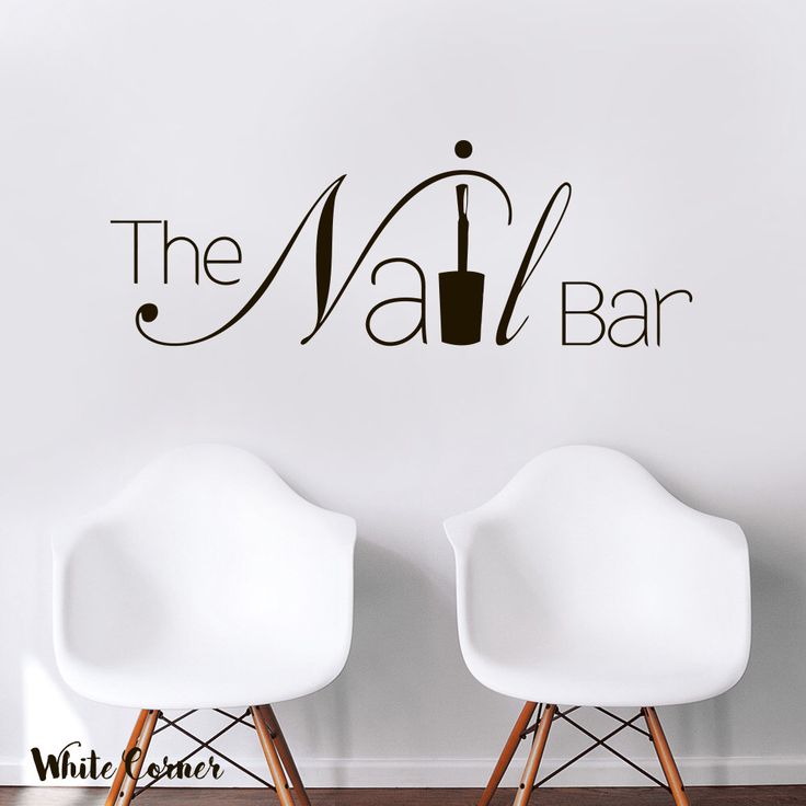 two white chairs in front of a wall that says the nail bar