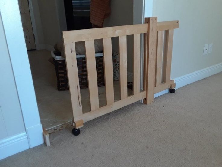 there is a wooden baby gate in the room