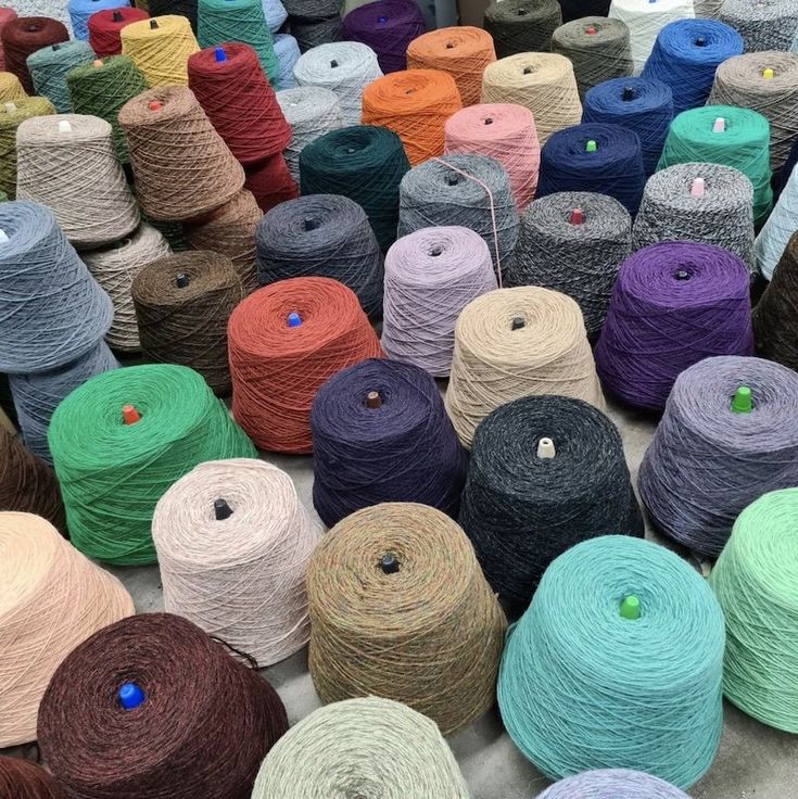 many skeins of yarn are laid out on the ground