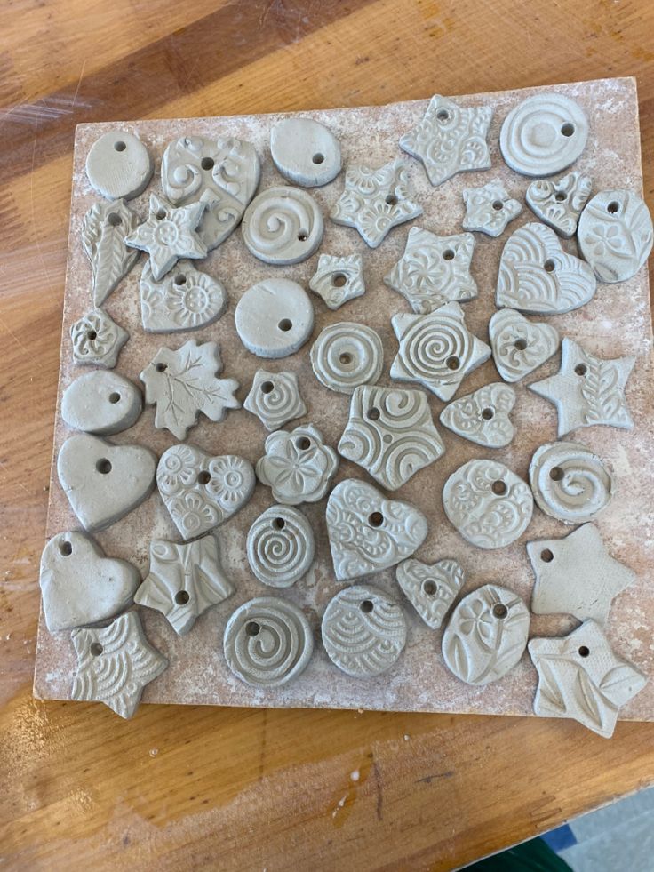 several different shapes and sizes of buttons on a table