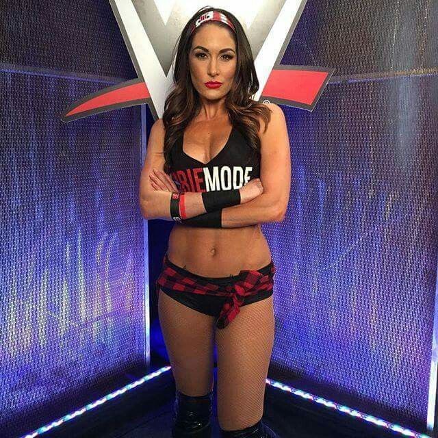 a female wrestler posing for the camera with her arms crossed