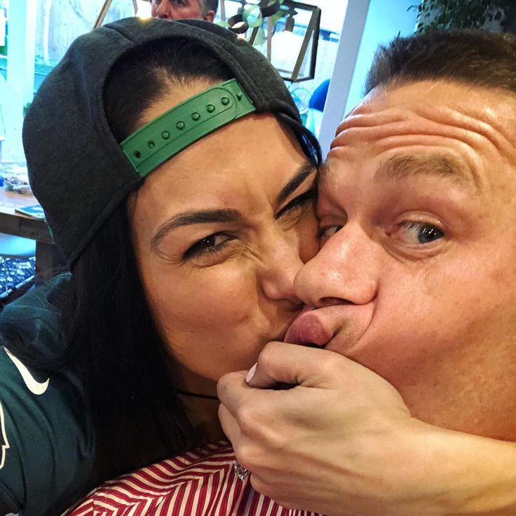 a man and woman kissing each other while wearing headbands on their foreheads