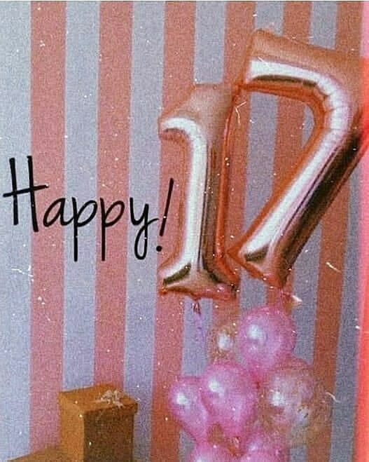 a pink and gold balloon with the number twenty on it in front of a striped wall