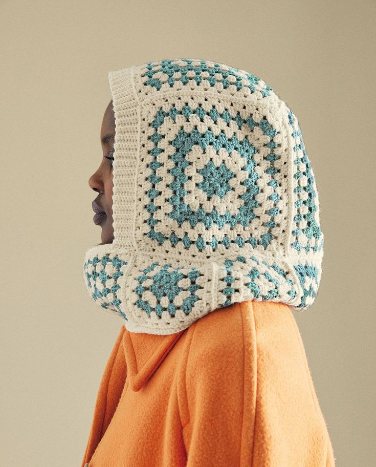 a woman wearing a crocheted hat with an eye on it