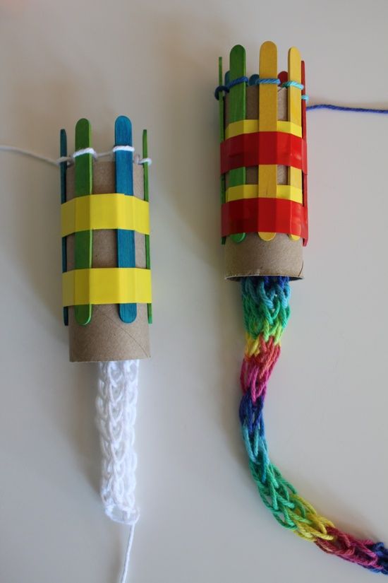 two colorful objects made out of paper on a white surface with wires attached to them