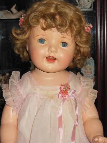 an old doll with blonde hair and blue eyes
