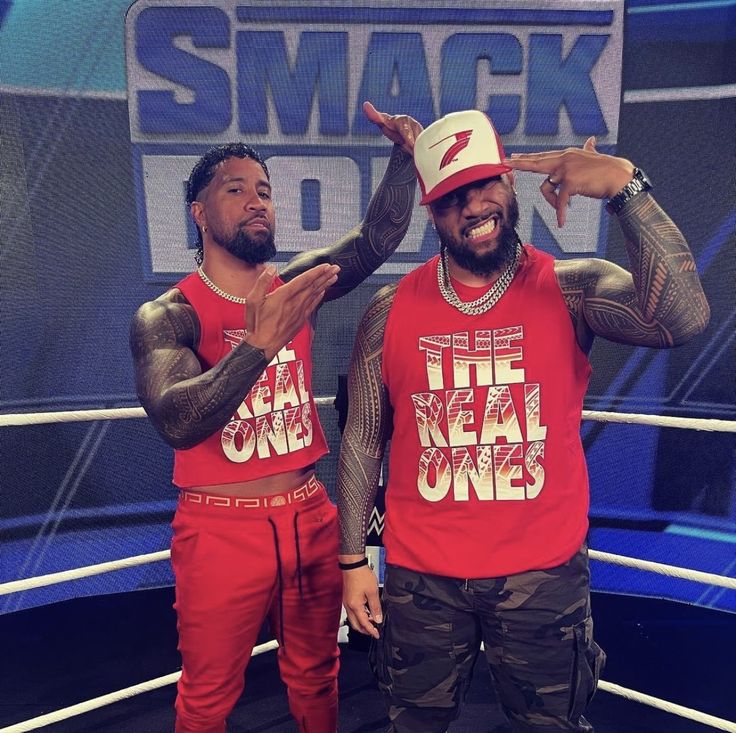 two men standing next to each other in front of a screen with the words smack don on it