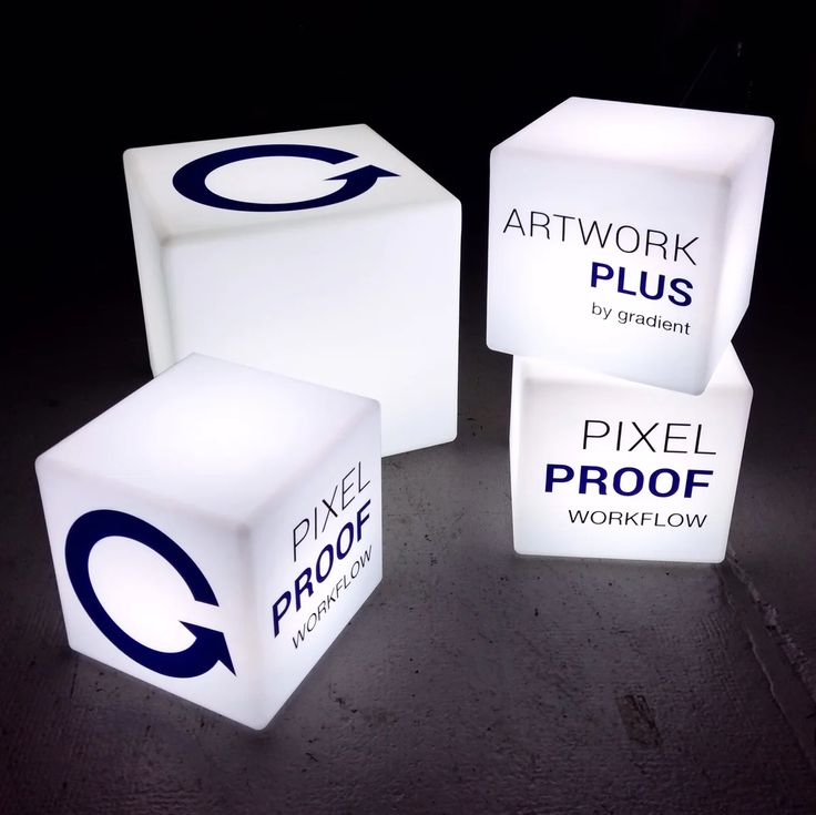 three illuminated cubes with the words art work plus and pixel proof written on them