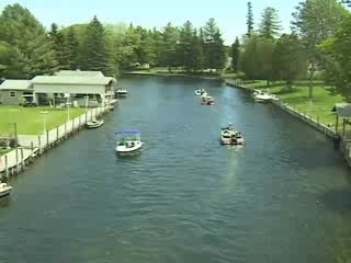 there are many small boats on the water in this town's riverfront area