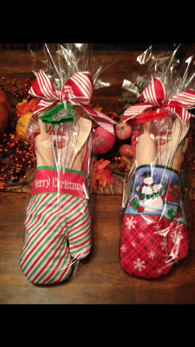 two christmas stockings wrapped in cellophane and sitting on a table with candy canes