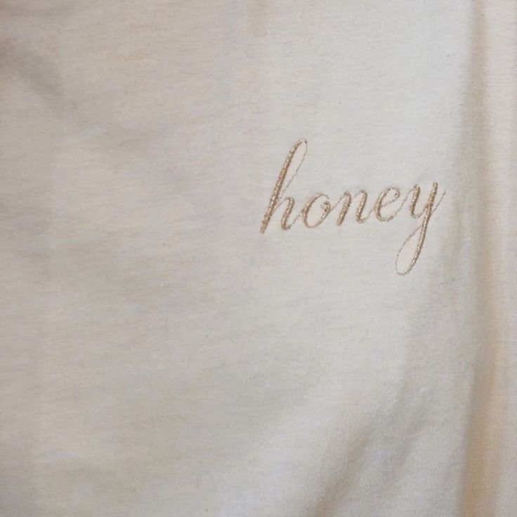 the word honey is embroidered on a white shirt