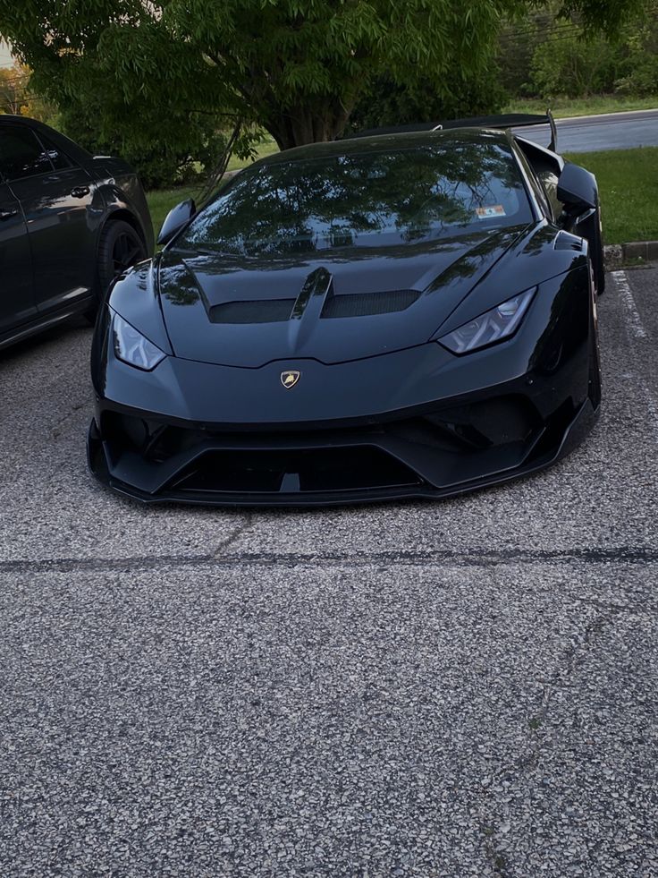 two black sports cars parked next to each other