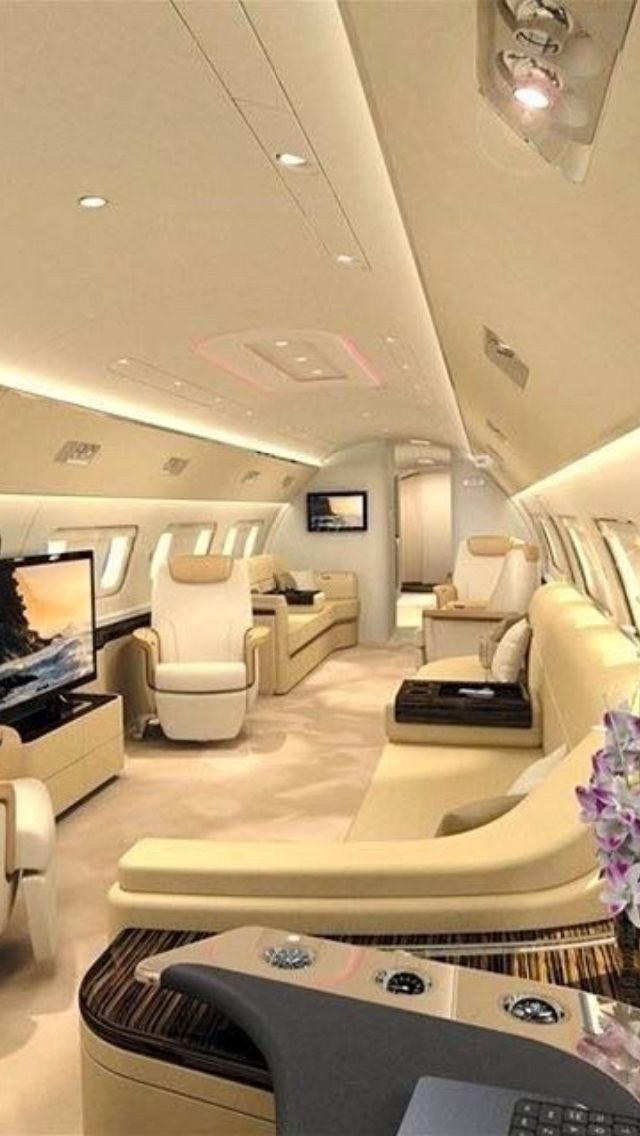 the inside of an airplane with couches and tables