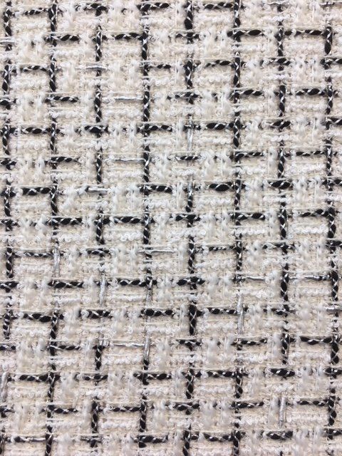 an up close shot of the texture of a white and black fabric with small squares