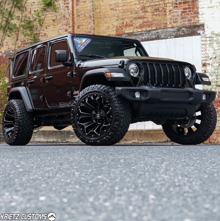 a black jeep parked in front of a brick building