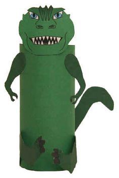 a green paper toy with an angry face and mouth