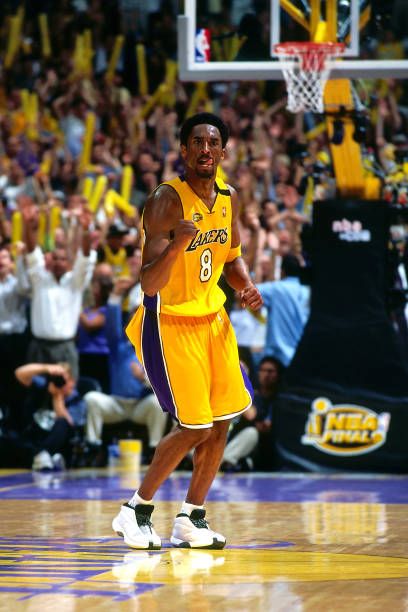 a basketball player is walking on the court with his hands in the air while fans are watching him