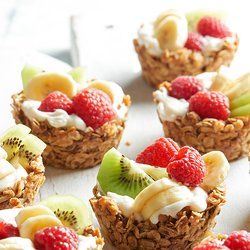 some fruit and yogurt cups are sitting on a table