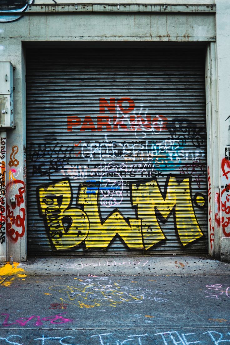 an open garage door with graffiti on it