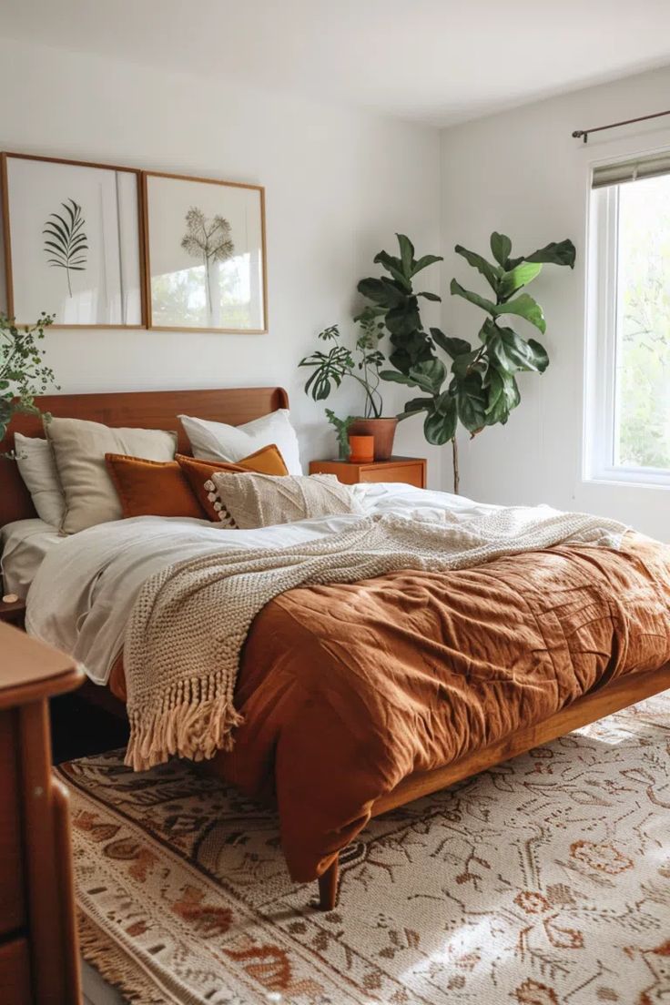 a bedroom with a bed, rug and plants