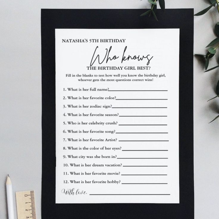 a black and white birthday wish card next to a pen, ruler and flowers on a table