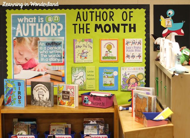 a classroom display with books and pictures on the wall, including an author of the month