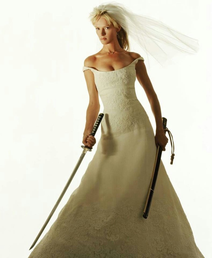 a woman in a wedding dress holding two swords