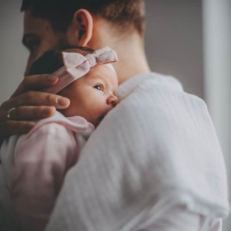 a man holding a baby in his arms