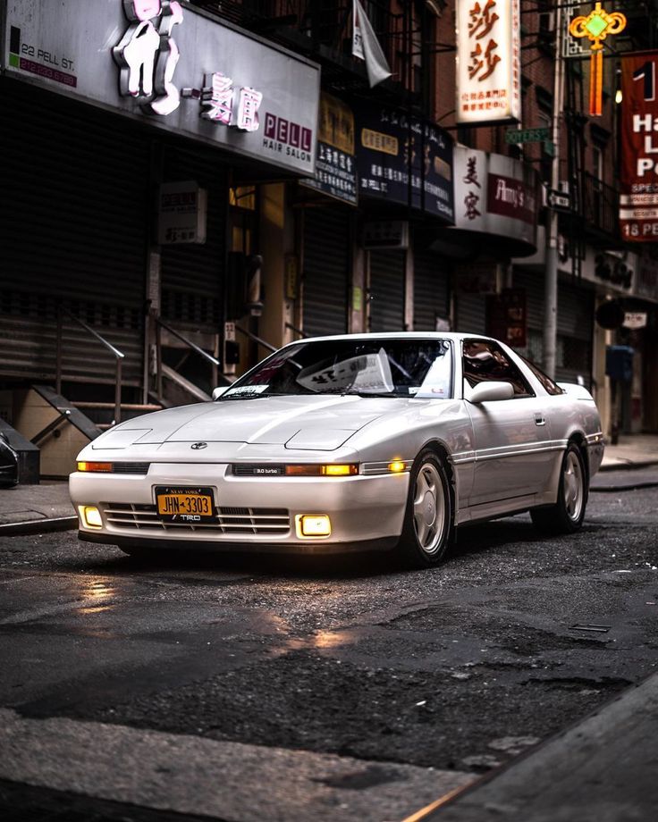 a white car parked on the side of a street