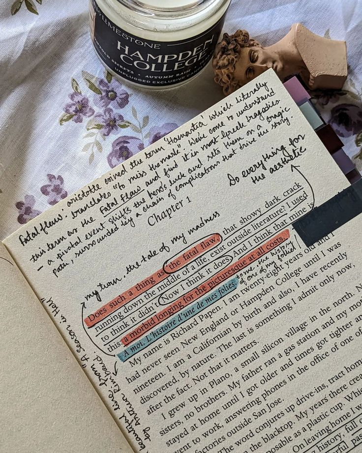 an open book with writing on it next to a jar of whipped cream