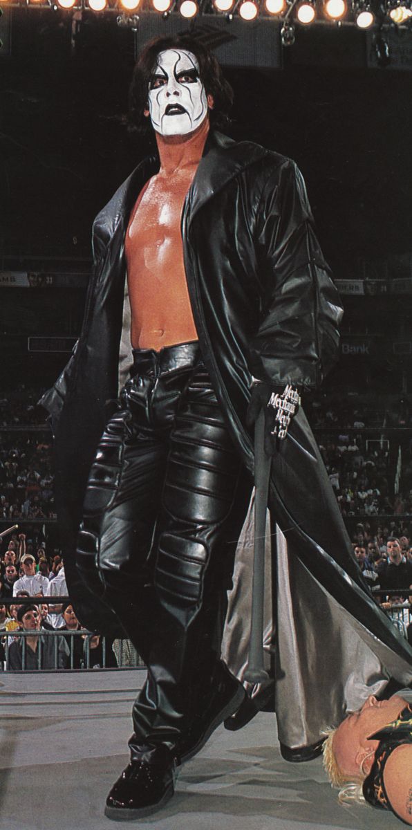 the wrestler is dressed in all black and white