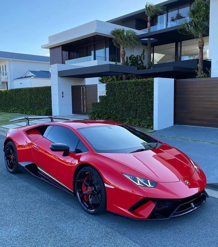 a red sports car parked in front of a house