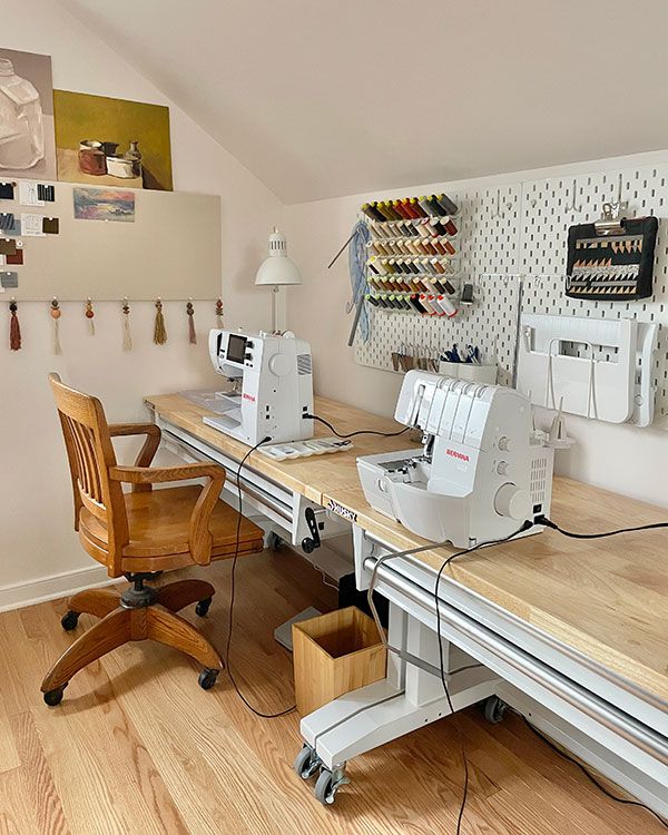 two sewing machines sitting on top of wooden desks