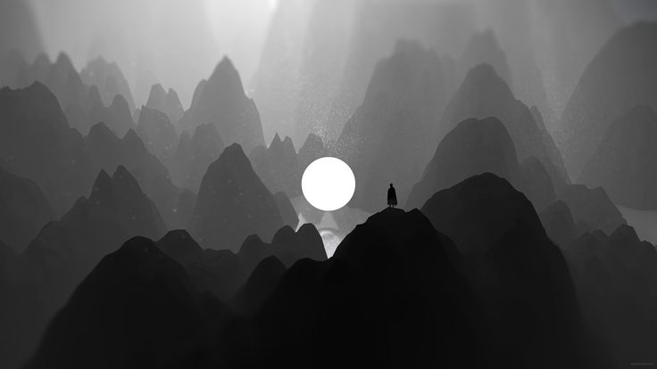 a person standing on top of a mountain with the sun shining through foggy mountains