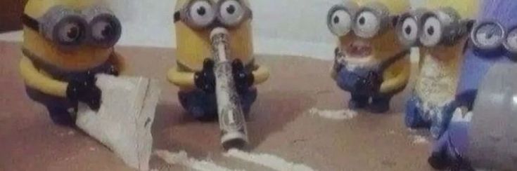 three minion figures are posed in front of each other