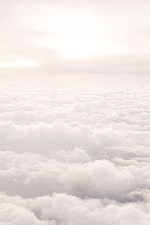the sky is filled with white clouds as seen from an airplane in the air above