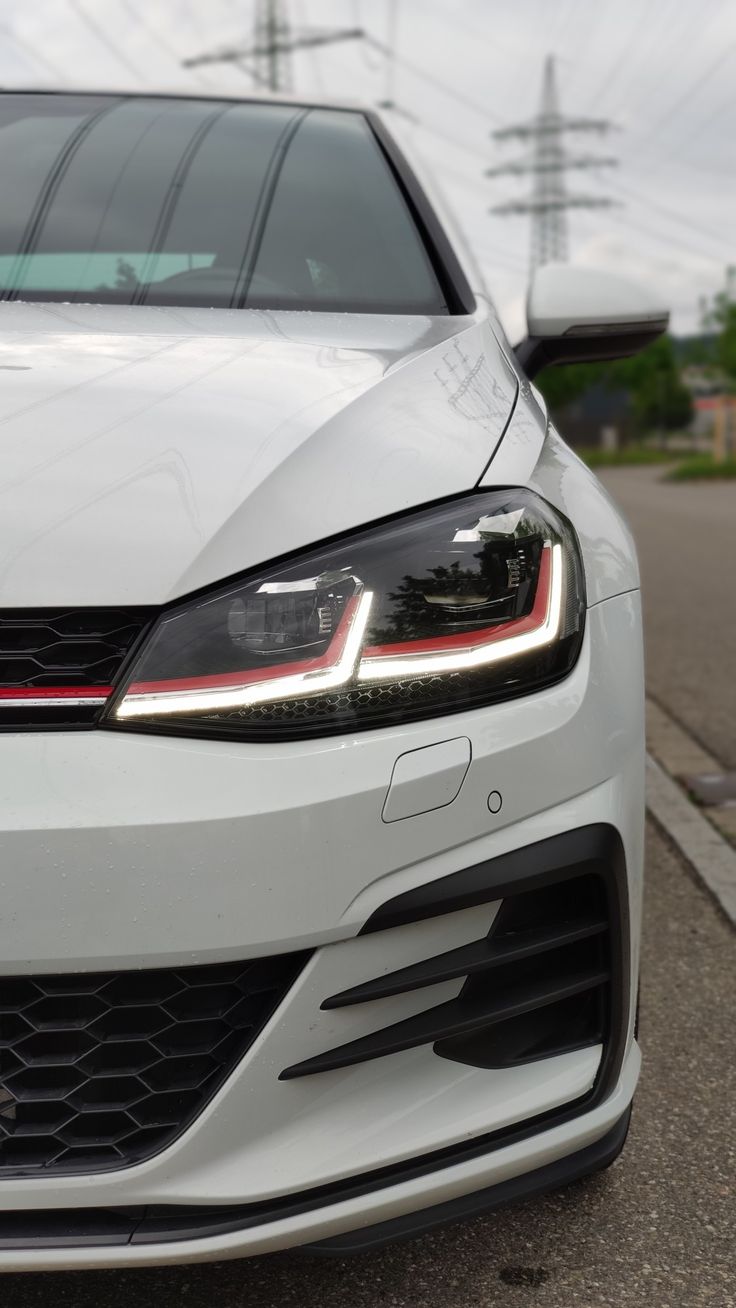 the front end of a white volkswagen car
