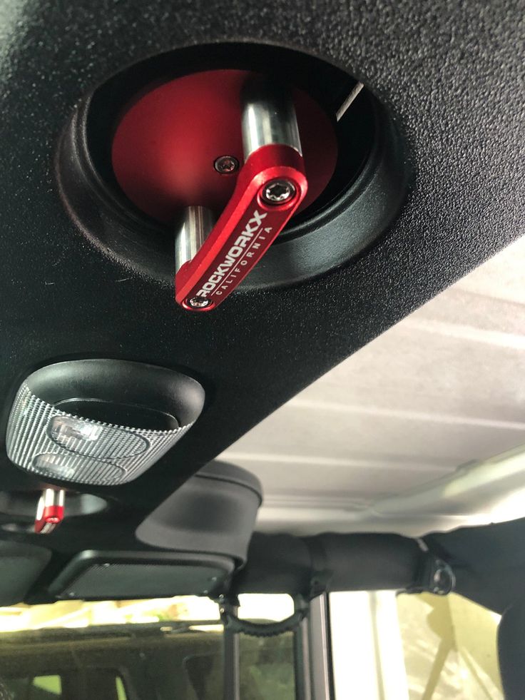 there is a red lever in the middle of this vehicle's door handle holder