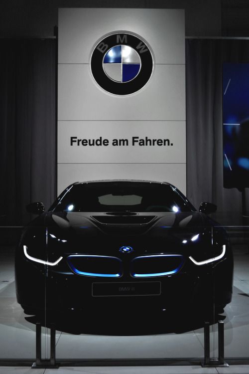 a black bmw car is on display in front of a sign that says, freude an fahren