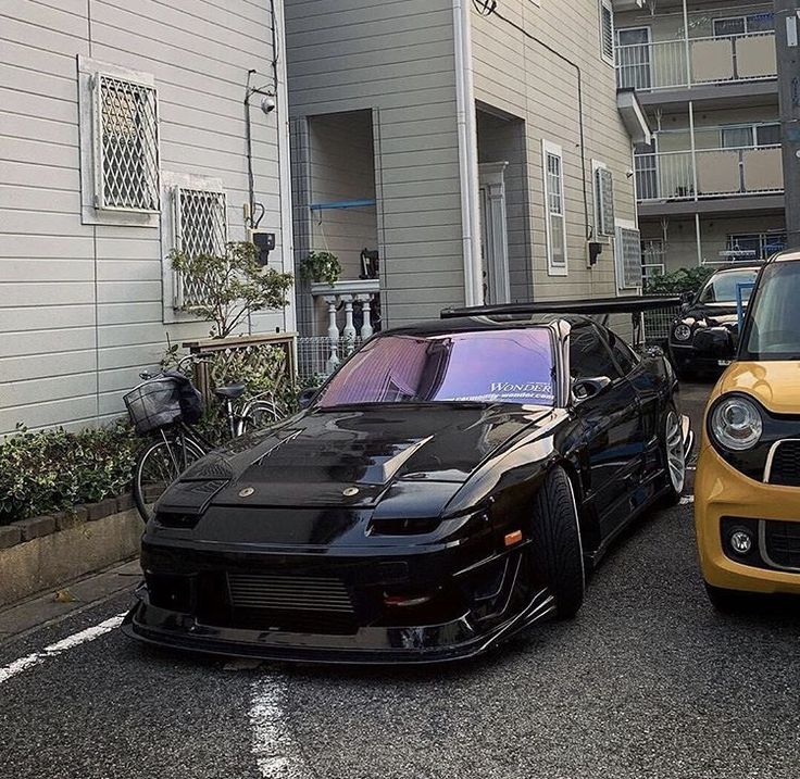 two cars parked next to each other on the street